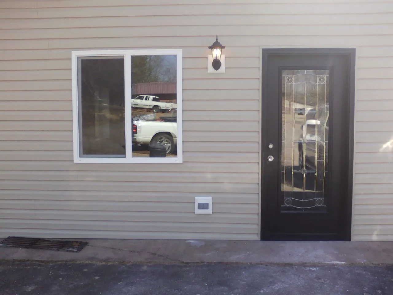 New siding, window and entry door on the side of an addition in Pipersville